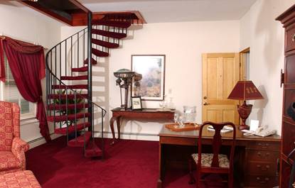 Auradell room with red carpet and red spiral staircase