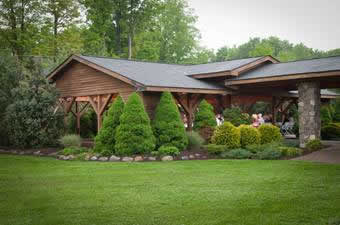 Holidays & Catering 15 Outside view of lawnhaven with trees and bushes surrounding the wooden facility