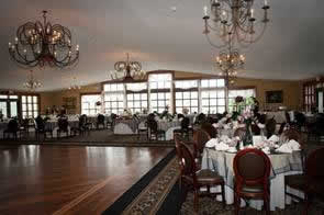 Holidays & Catering 20 Ridgecrest dining hall with chandeliers and table settings in white