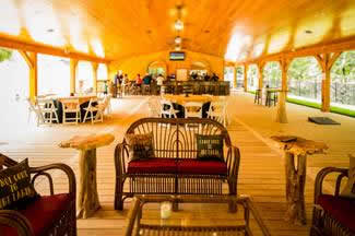 Holidays & Catering 17 under the pavilion with red lounge chairs