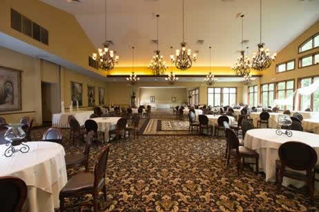 Holidays & Catering 26 Terraview dining hall with multiple chandeliers and tables set in black cloths