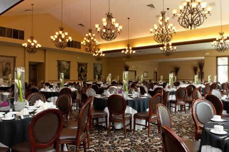 Holidays & Catering 27 Terraview dining hall with multiple chandeliers and tables set in black cloths