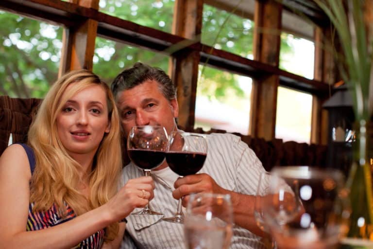 Couple enjoying wine - making toast