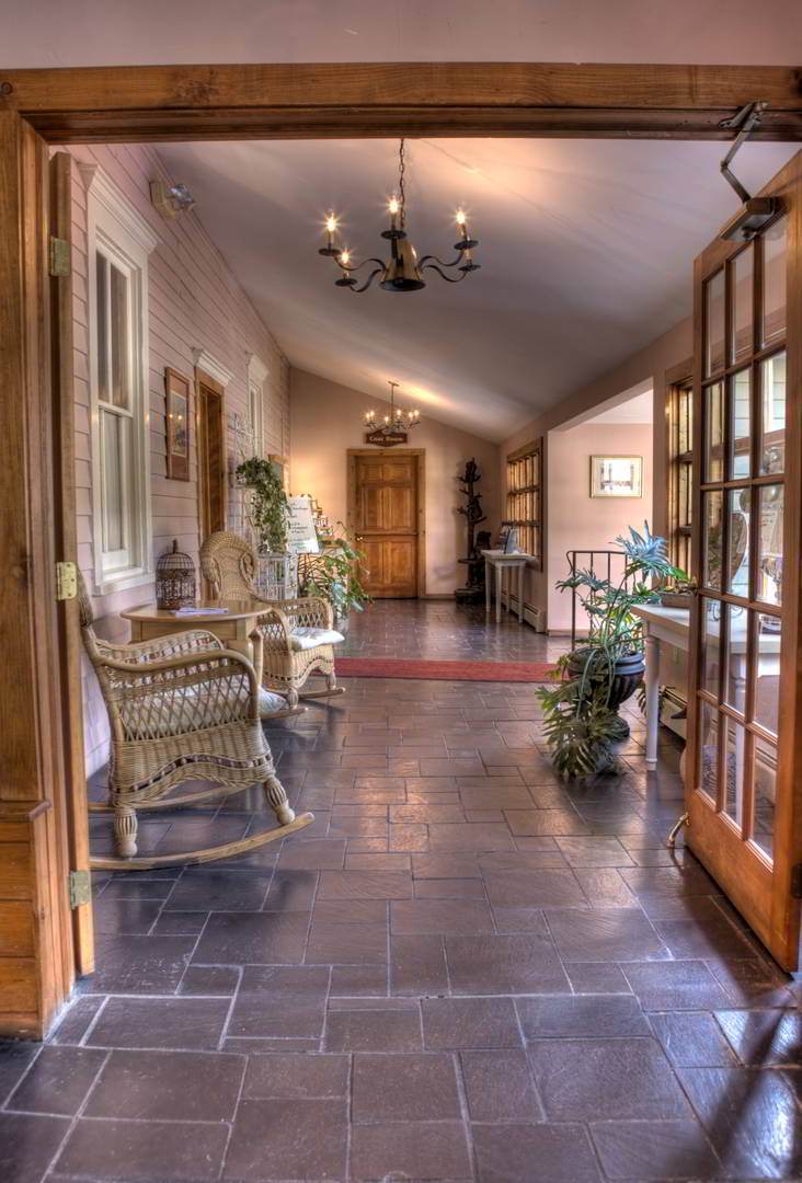 Poconos Lodging: Delight in the Cozy Comforts 1 Main Inn breezeway, rocking chairs, tile floors.