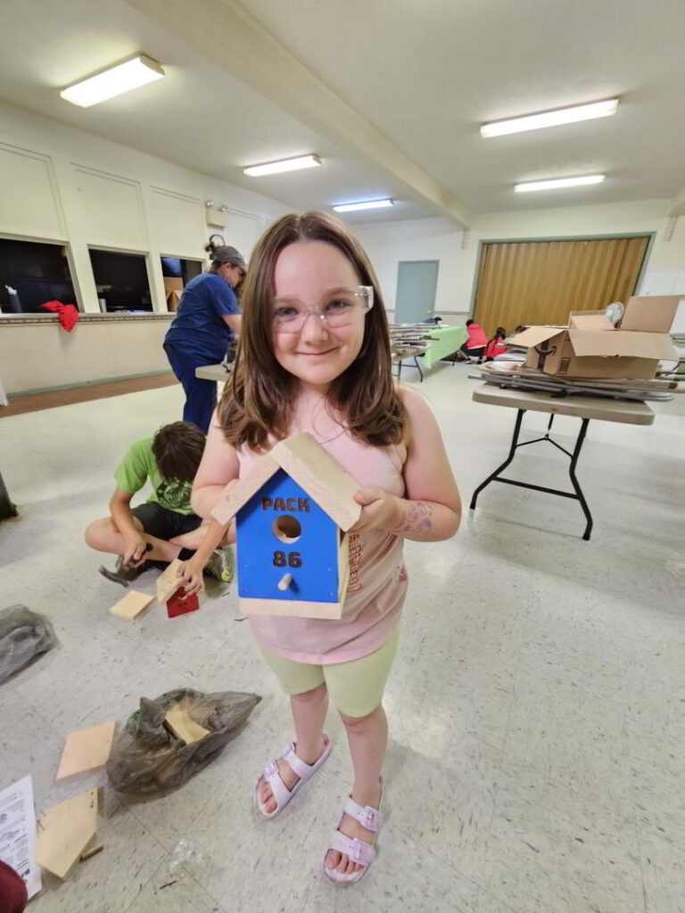 scout 86 holding birdhouse