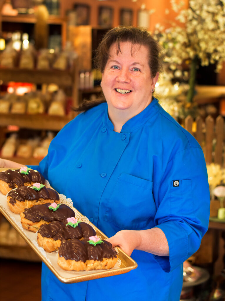 Baker holds tray of pastries