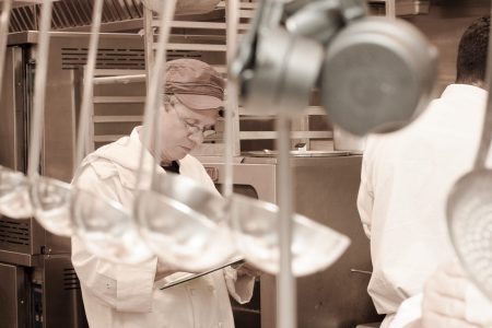 Chef looks over menu in Terraview kitchen